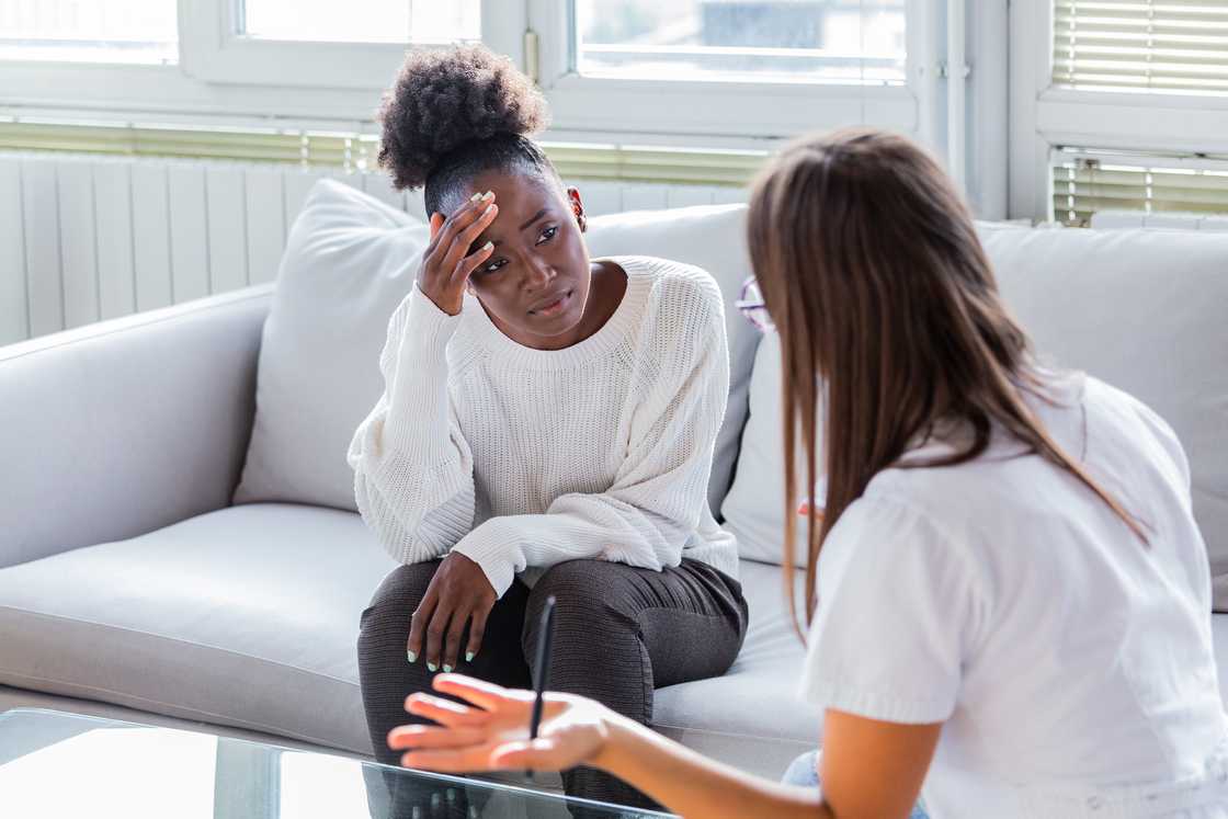 A woman speaks with a therapist at the counseling office.