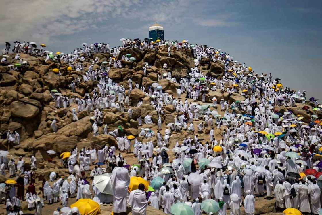 Muslim pilgrims gather atop Mount Arafat, southeast of the holy city of Mecca. This year, participation was capped at almost one million fully vaccinated worshippers Muslim pilgrims gather atop Mount Arafat, southeast of the holy city of Mecca. This year, participation was capped at almost one million fully vaccinated worshippers