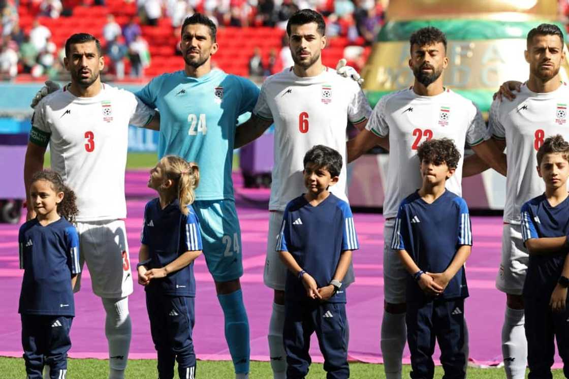 Iran's players sing their national anthem prior to the game against Wales