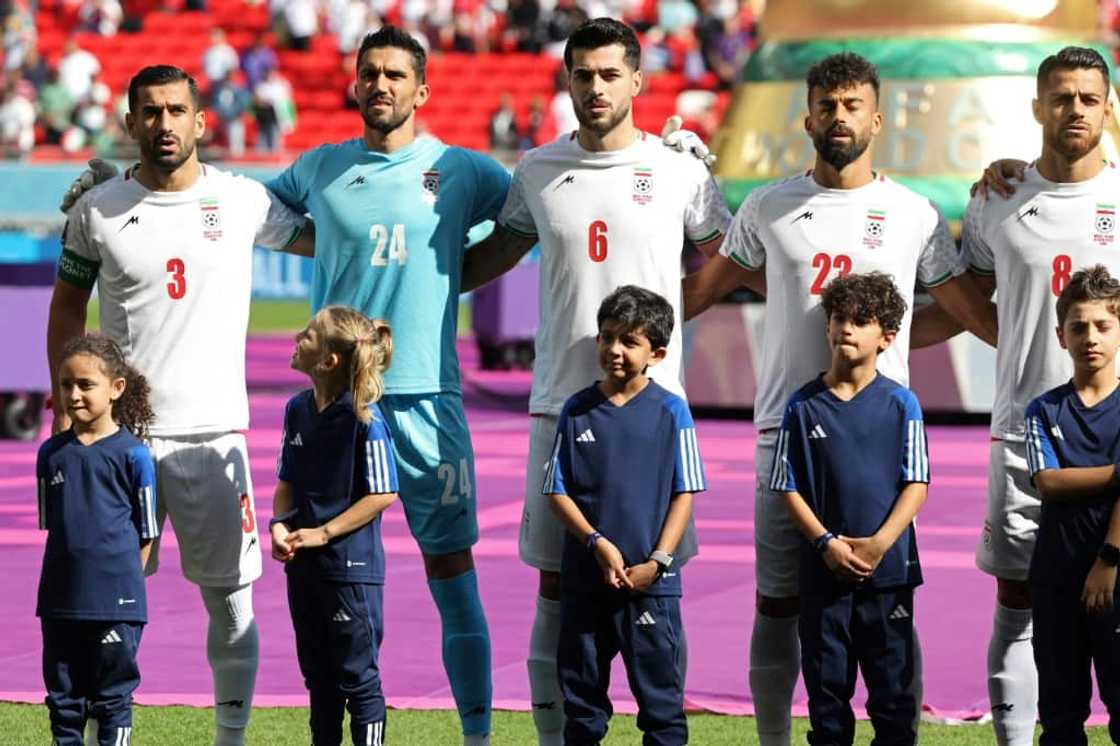 Iran's players sing their national anthem prior to the game against Wales Iran's players sing their national anthem prior to the game against Wales