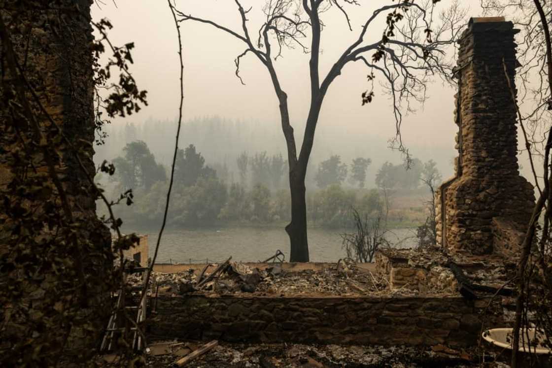 A chimney is all that remains of a river-front home in Klamath River northwest of Yreka, California