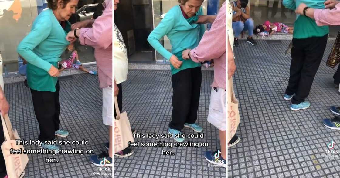 An old lady standing with a rat in her clothes An old lady standing with a rat in her clothes