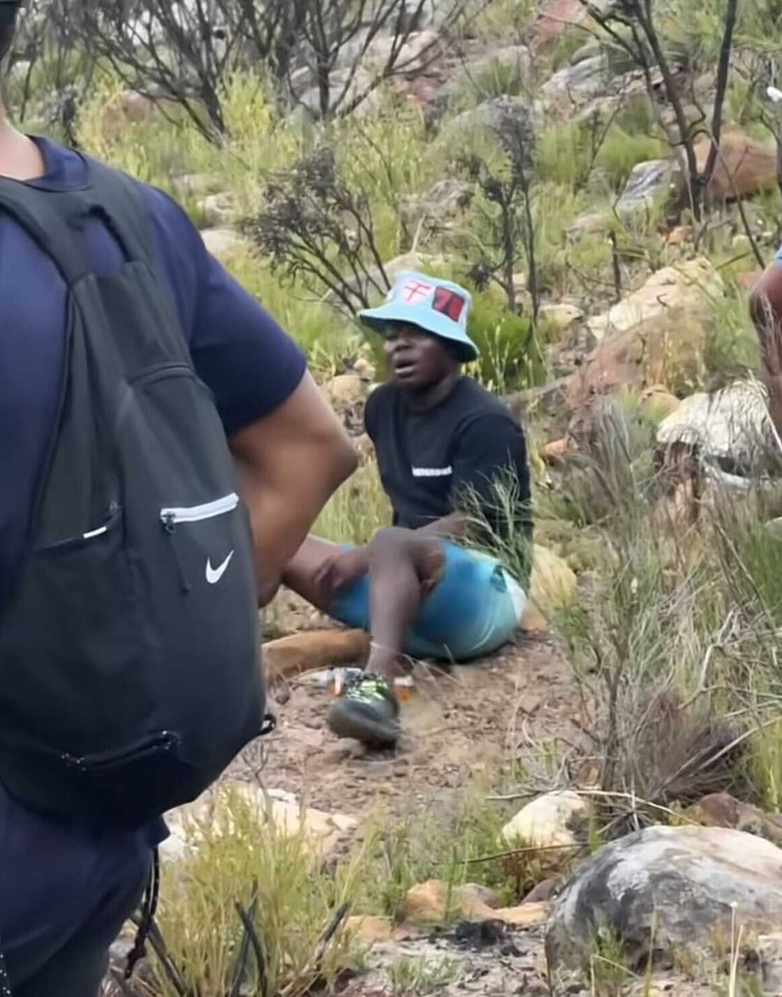 A man was exhausted from the hike in Cape Town. A man was exhausted from the hike in Cape Town.