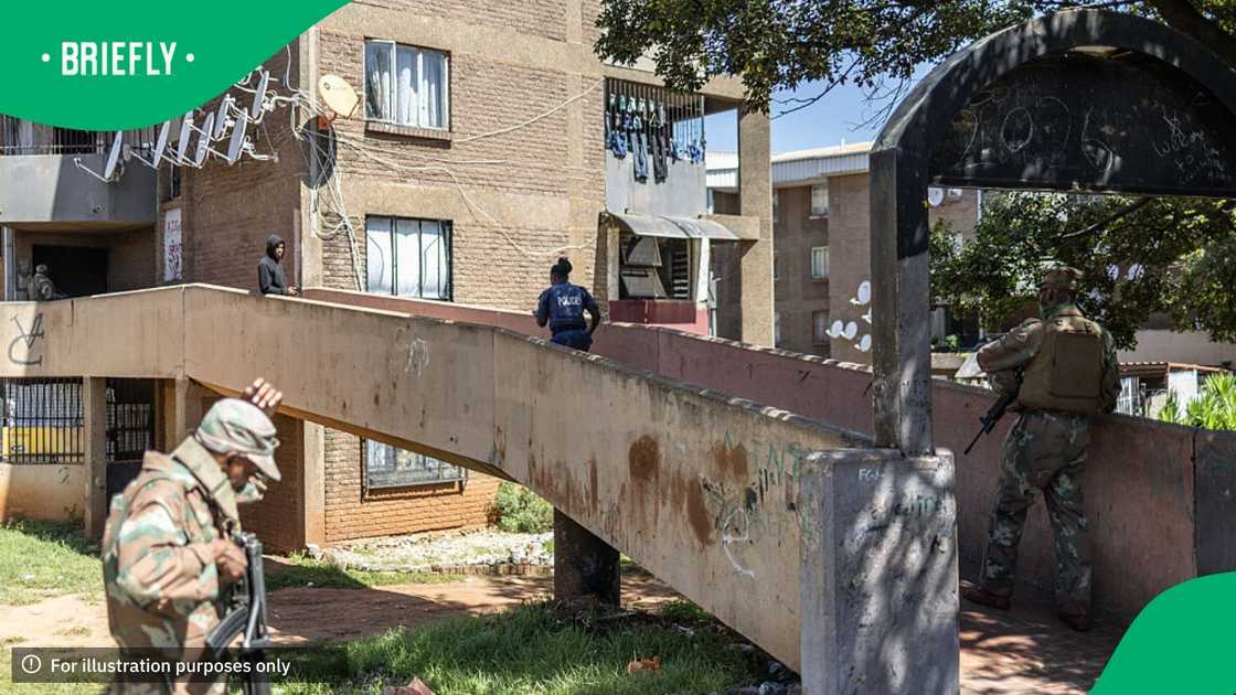 South Africa Police Service (SAPS) officers and South African National Defence Force (SANDF) soldiers search a building during a patrol operation in Westbury, near Johannesburg, on March 11, 2026 South Africa Police Service (SAPS) officers and South African National Defence Force (SANDF) soldiers search a building during a patrol operation in Westbury, near Johannesburg, on March 11, 2026