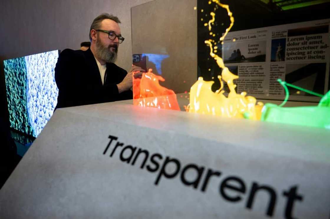 A person looks at a Samsung transparent micro led TV as the South Korean consumer electronics giant shows off innovations built into its latest displays, with artificial intelligence a major theme