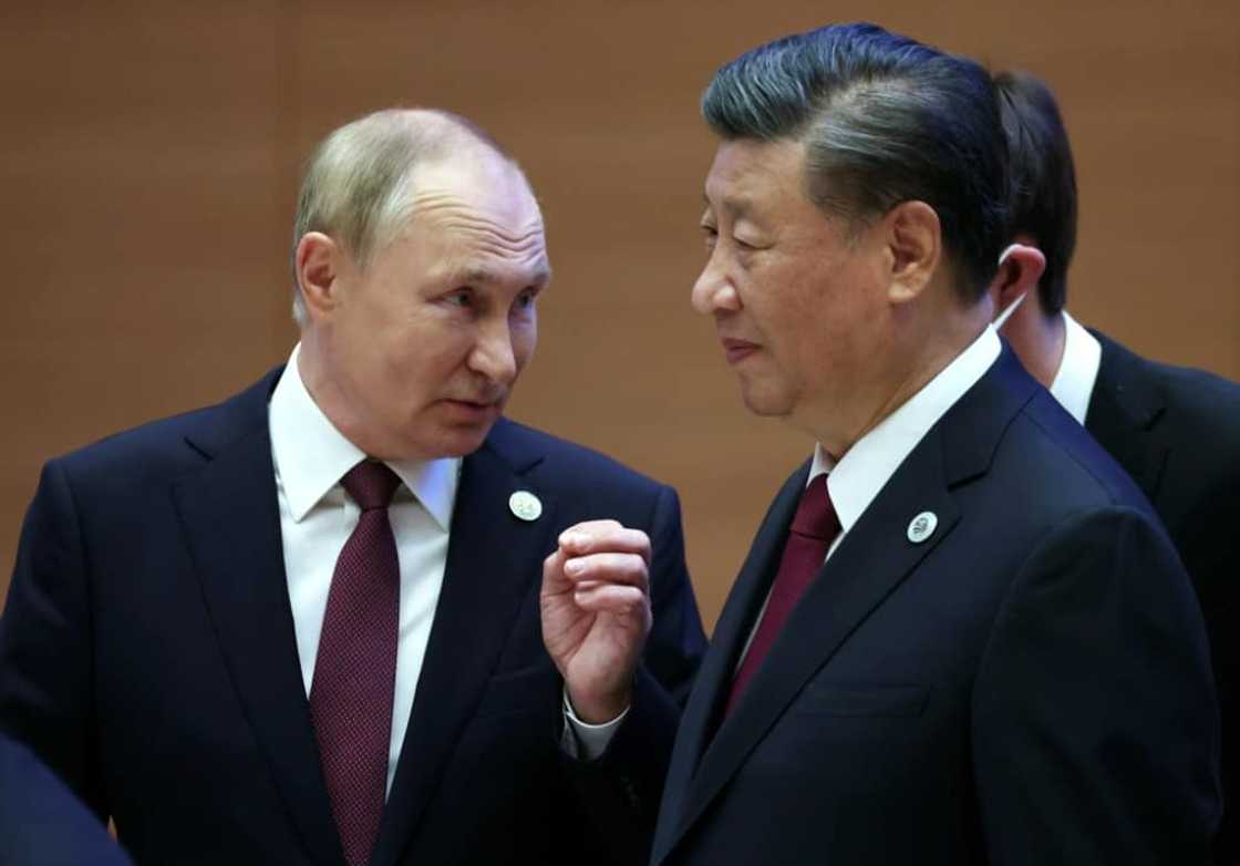 Russian President Vladimir Putin speaks to China's President Xi Jinping during the Shanghai Cooperation Organisation leaders' summit in Samarkand on September 16, 2022 Russian President Vladimir Putin speaks to China's President Xi Jinping during the Shanghai Cooperation Organisation leaders' summit in Samarkand on September 16, 2022