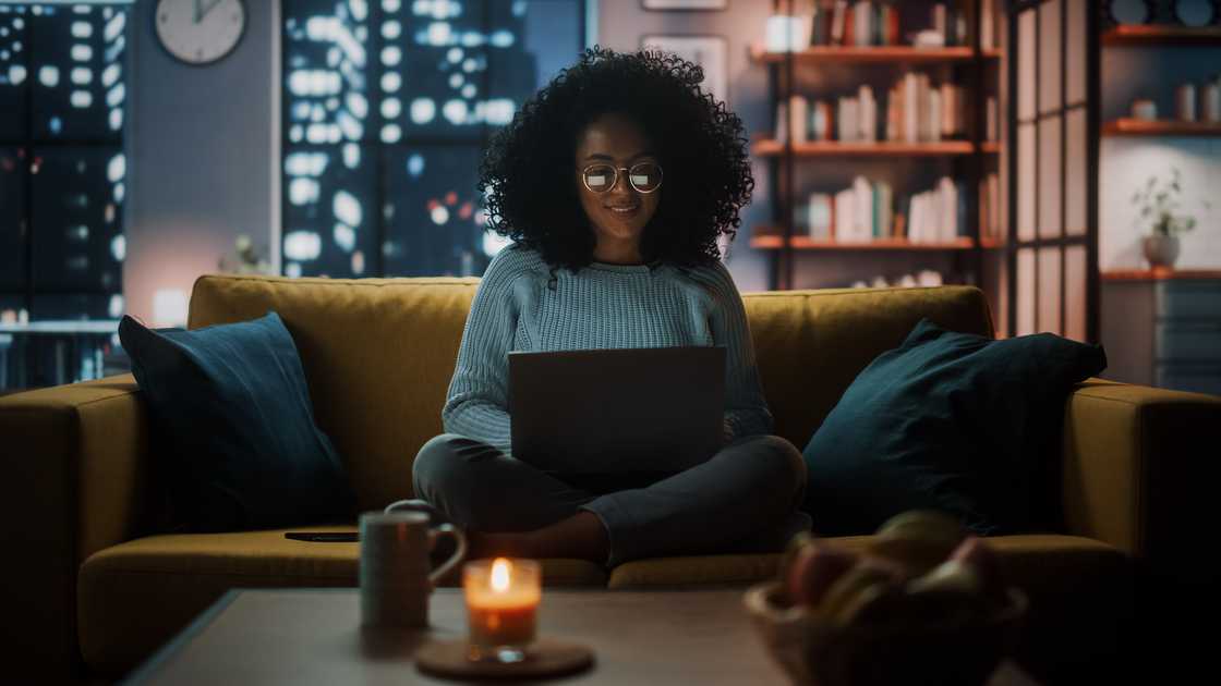 A lady at home with a burning candle A lady at home with a burning candle