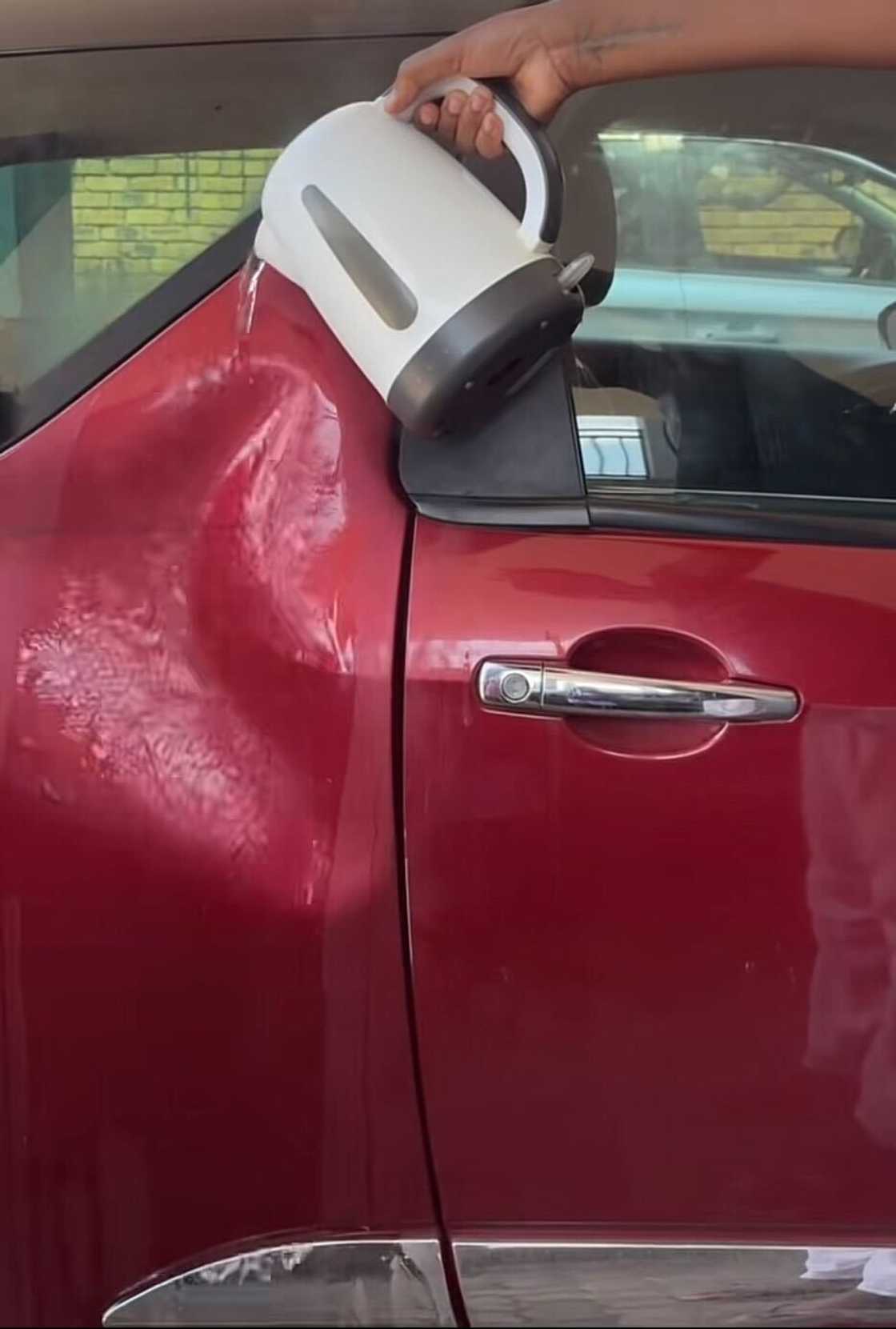 A woman demonstrated how she fixed a dented car using hot water. A woman demonstrated how she fixed a dented car using hot water.
