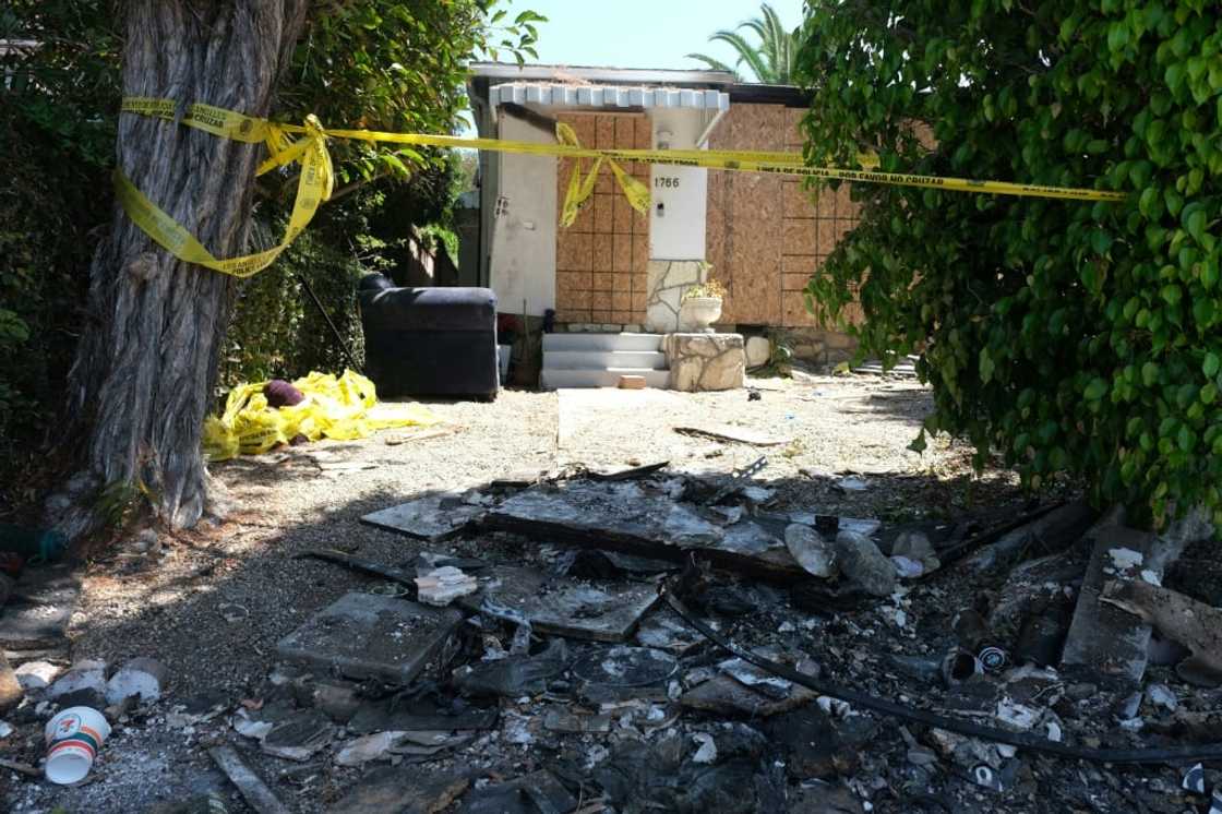 Charred debris and caution tape are seen at the home where US actress Anne Heche crashed her car last week Charred debris and caution tape are seen at the home where US actress Anne Heche crashed her car last week