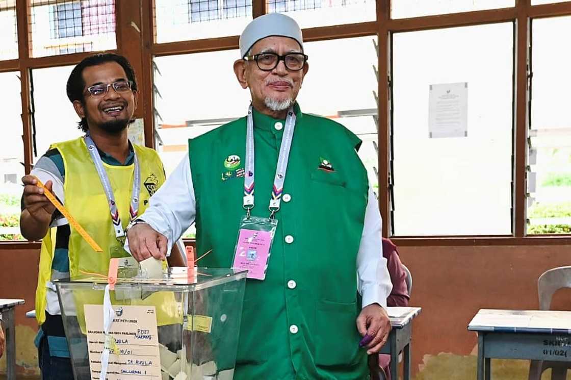 The conservative Pan-Malaysian Islamic Party (PAS), led by Abdul Hadi Awang (R), has made big gains in the latest election