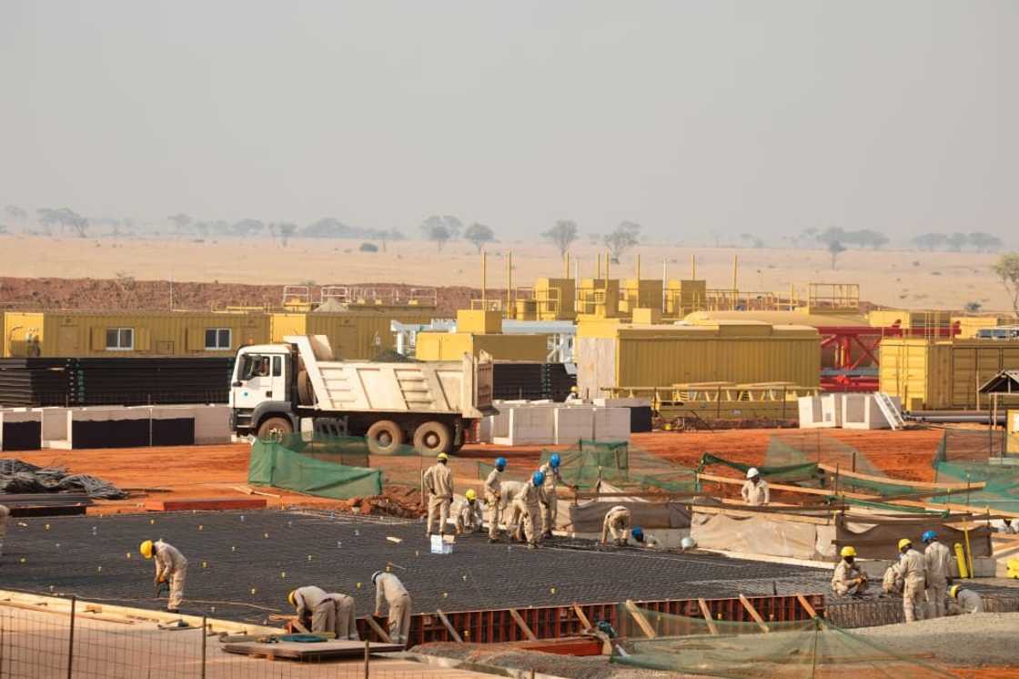 TotalEnergies employees working on an oil well pad inside Murchison Falls National Park in western Uganda, which will supply crude for a 1,443-kilometre pipeline to a Tanzanian port on the Indian Ocean