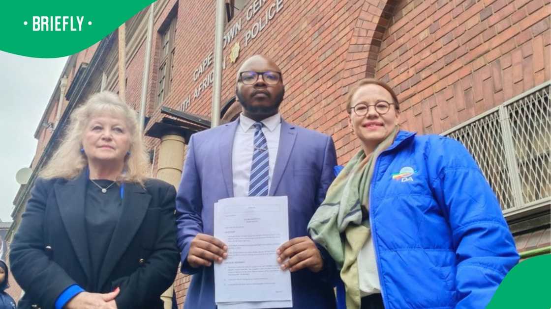 Members of the DA stand in front of the Cape Town Police Station