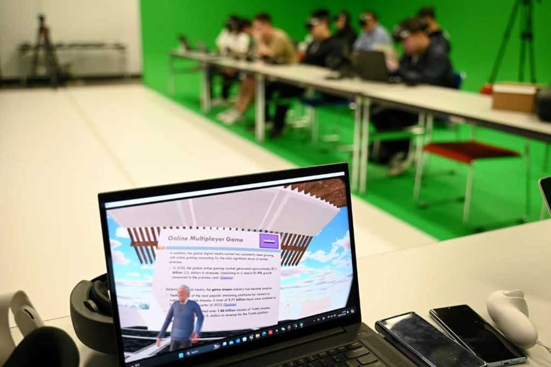 A laptop screen shows the first-person view of a virtual reality headset worn by a student  at the Hong Kong University of Science and Technology