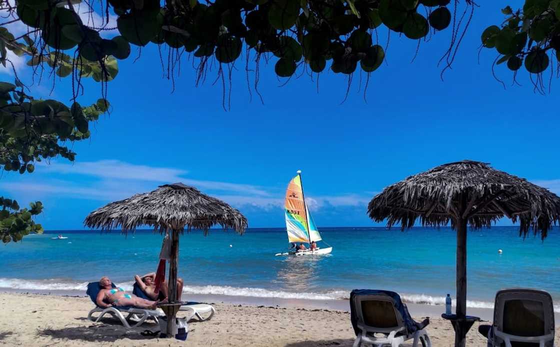 Tourists enjoy the sunshine at Jibacoa Beach, in Cuba's Mayabeque Province, on August 1, 2022; the country says tourism is recovering from a dropoff the last two years