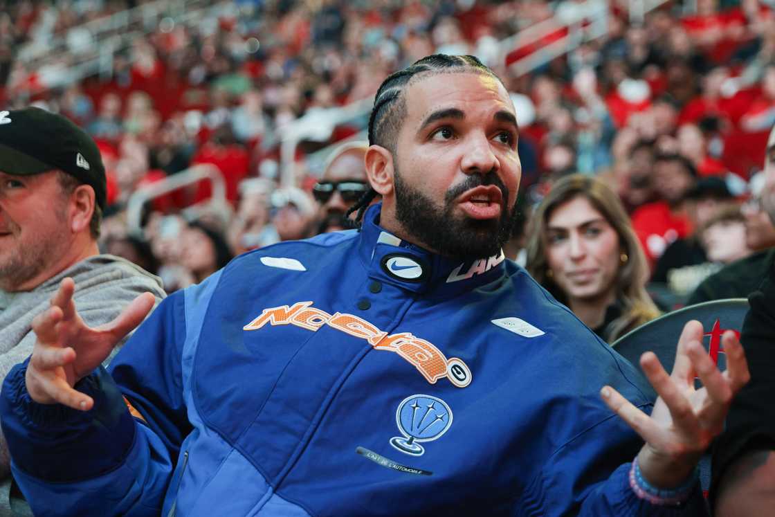 Drake was dressed in a black hoodie with bullet-holes Drake was dressed in a black hoodie with bullet-holes