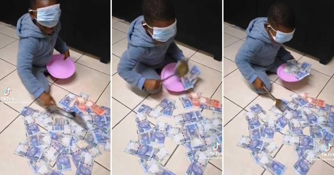 Child scooping money onto a plate while blindfolded Child scooping money onto a plate while blindfolded