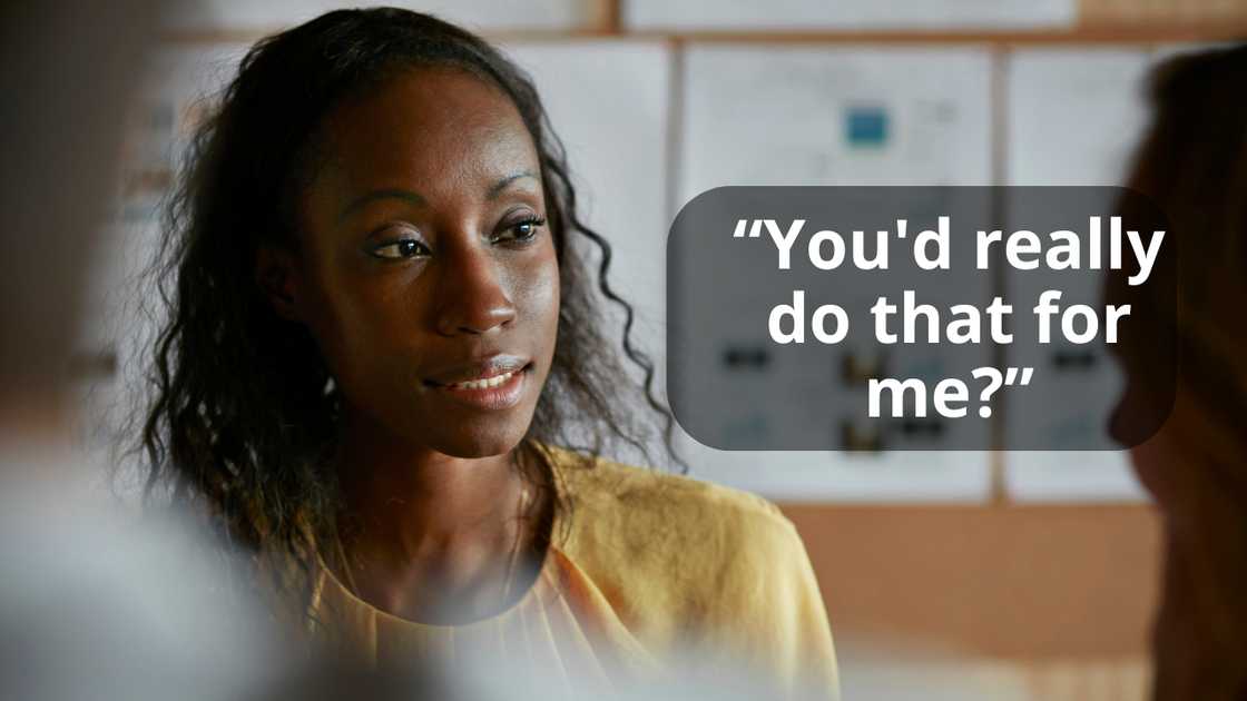 A woman talking with a friend indoors