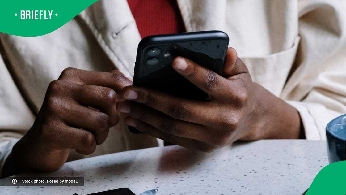 A woman typing on her phone. A woman typing on her phone.