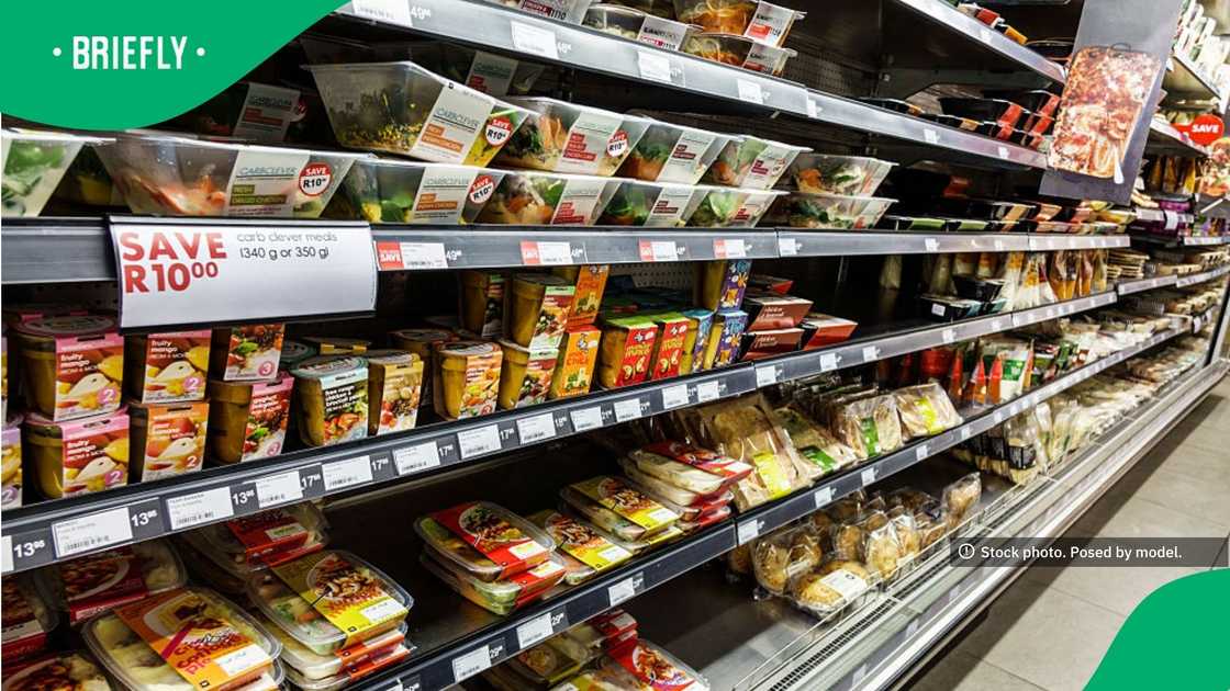 The wide shot captured rows of ready-to-eat food options, baby purees, and baked goods stacked within a Woolworths refrigerator unit The wide shot captured rows of ready-to-eat food options, baby purees, and baked goods stacked within a Woolworths refrigerator unit