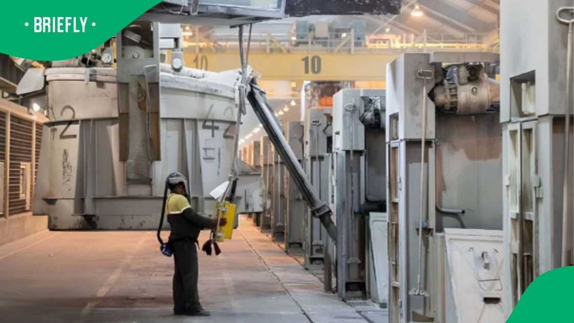 The photograph captured a clear view of an industrial manufacturing line where a plant worker controlled specialised smelting equipment using a hand-held pendant The photograph captured a clear view of an industrial manufacturing line where a plant worker controlled specialised smelting equipment using a hand-held pendant