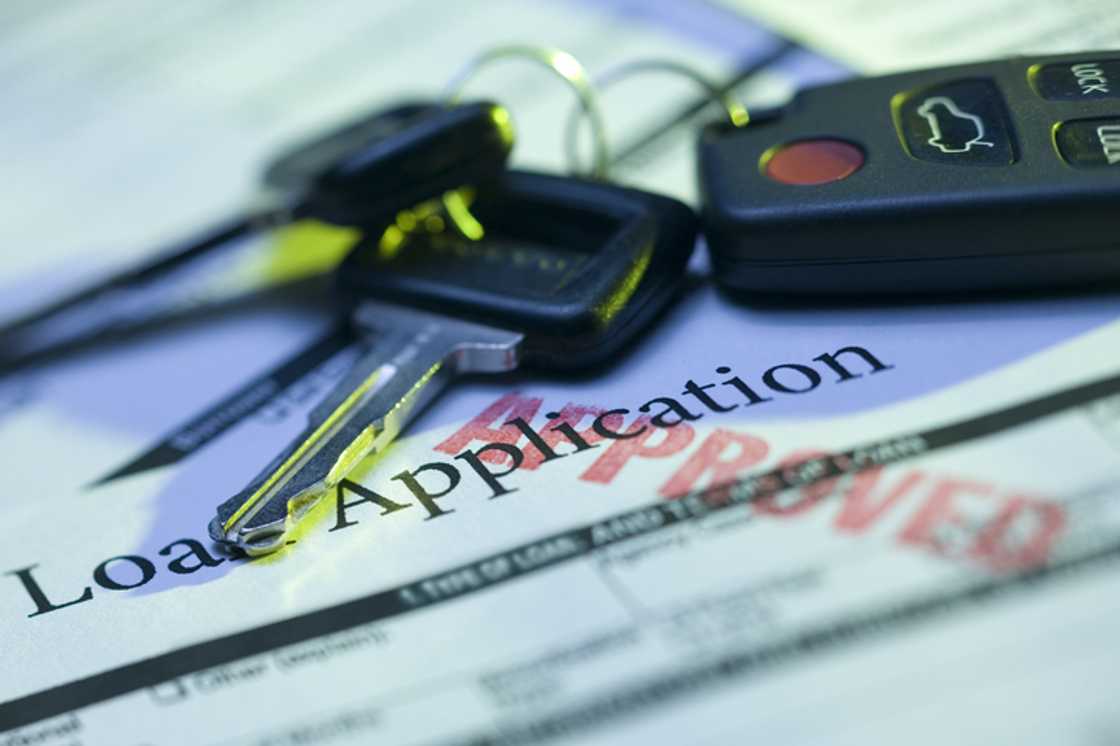 Car keys and approved loan application Car keys and approved loan application
