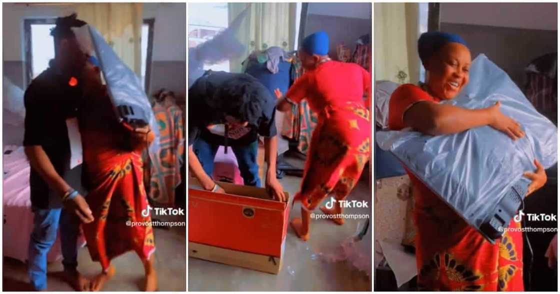 A woman dances for her son after he bought her a new TV