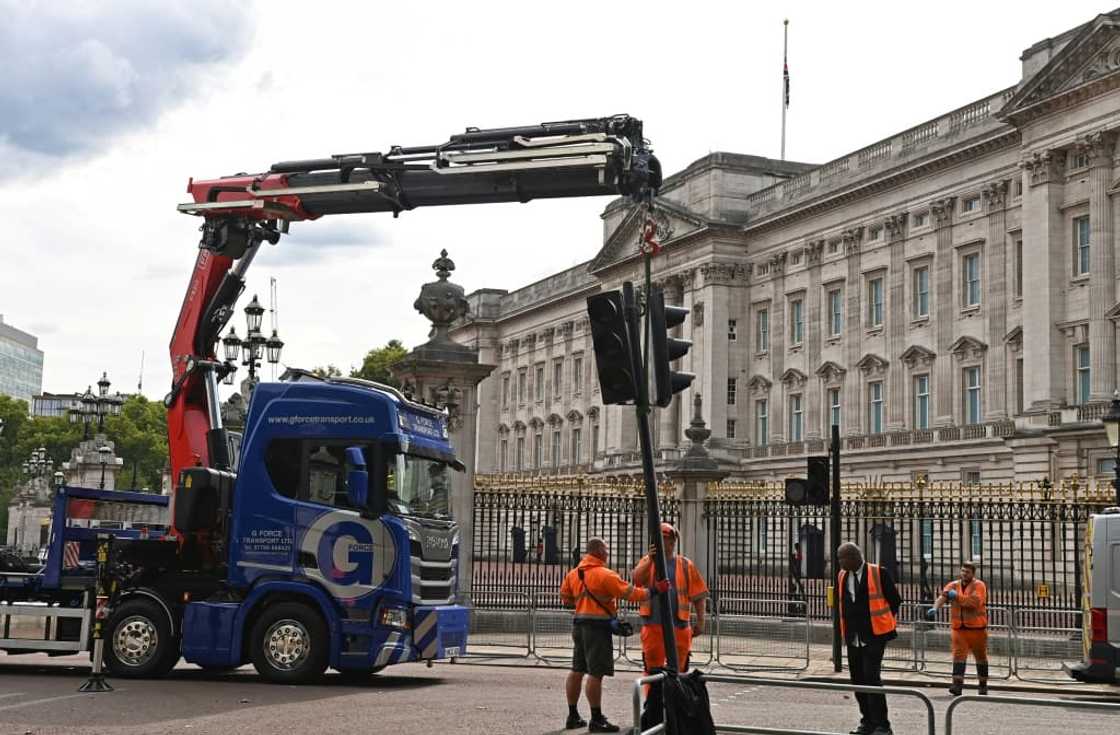 Workers re-installed traffic lights, removed for the funeral of Queen Elizabeth II, outside Buckingham Palace Workers re-installed traffic lights, removed for the funeral of Queen Elizabeth II, outside Buckingham Palace