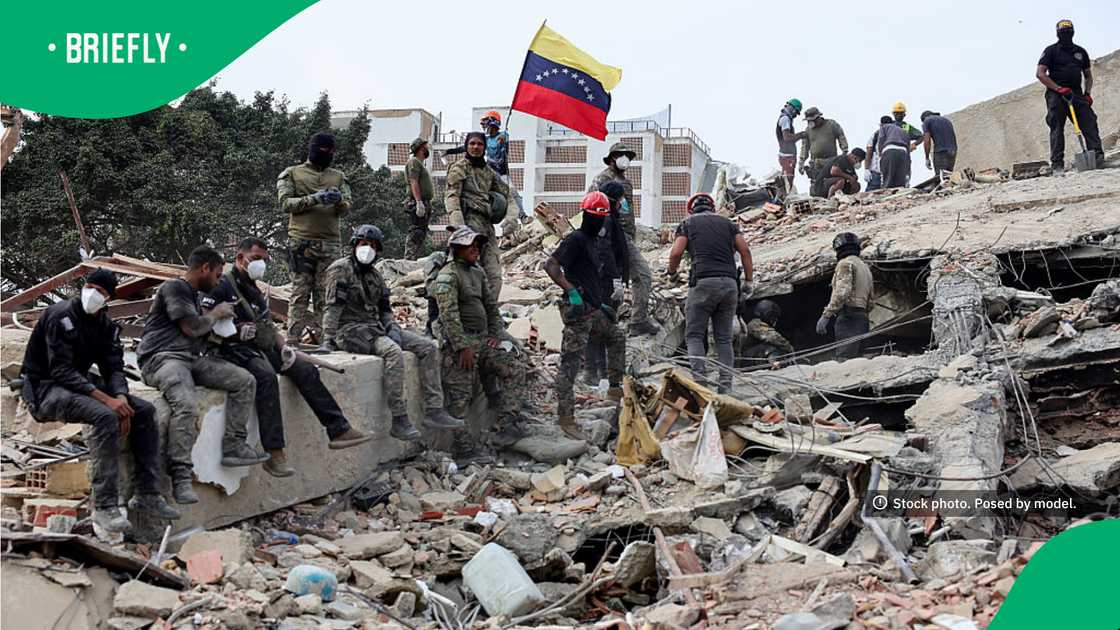Rescuers searched for victims at a collapsed building as one raised a Venezuelan flag Rescuers searched for victims at a collapsed building as one raised a Venezuelan flag