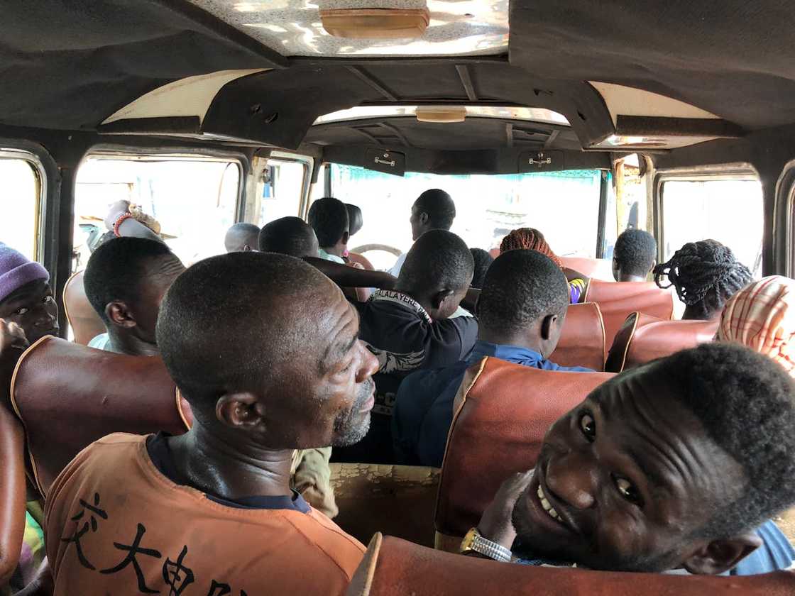 Passengers seated inside a crowded public minibus.