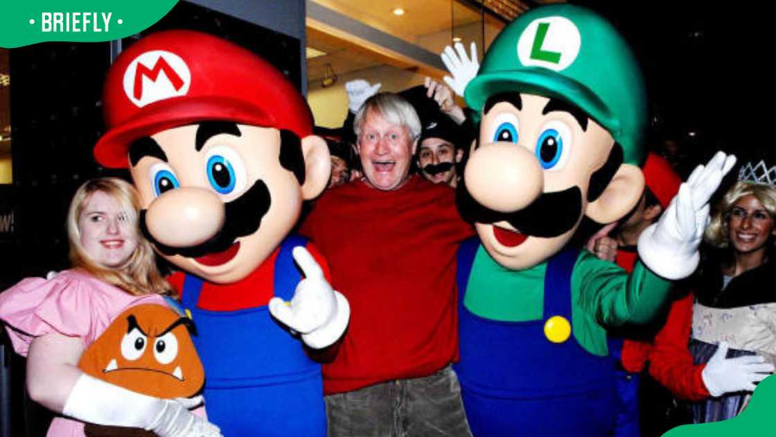 The voice of Super Mario, Charles Martinet (center), poses with fans