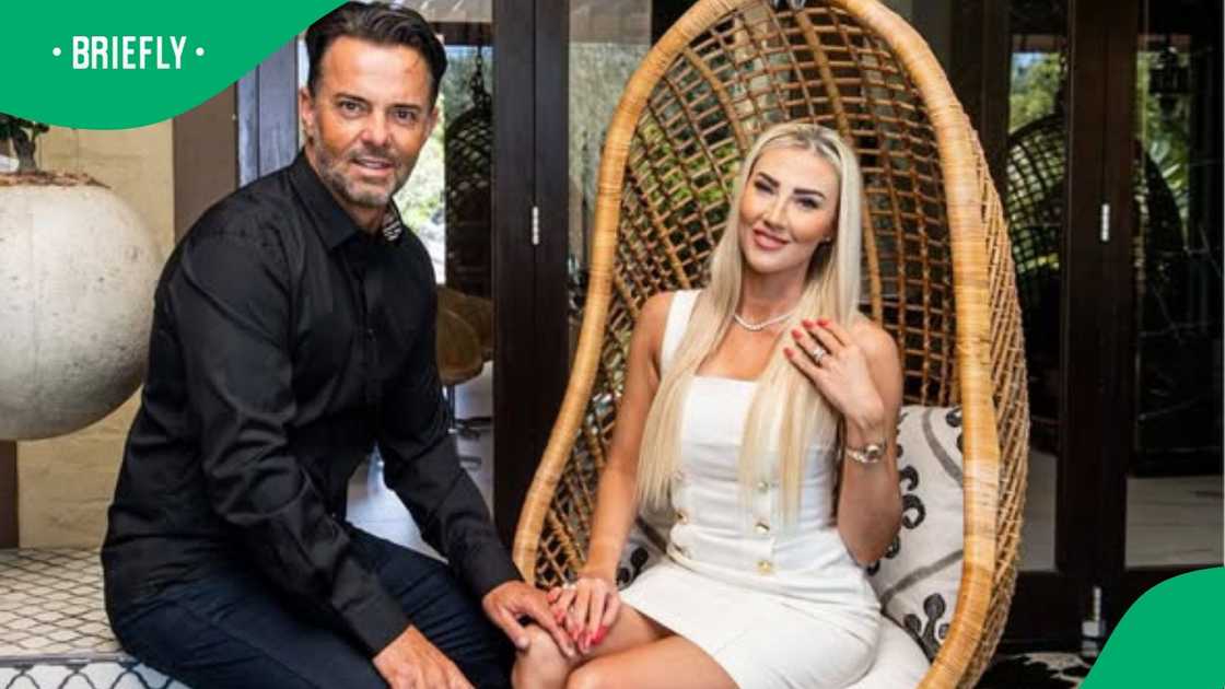 The portrait showed the well-known South African couple posing together outdoors on a patio setup The portrait showed the well-known South African couple posing together outdoors on a patio setup