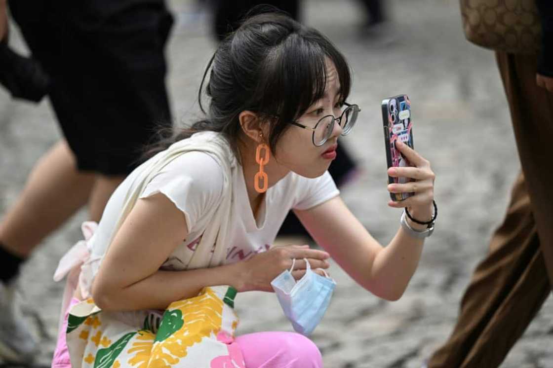 A Chinese tourist takes a photo in Macau during the country’s week-long holiday at the start of October A Chinese tourist takes a photo in Macau during the country’s week-long holiday at the start of October