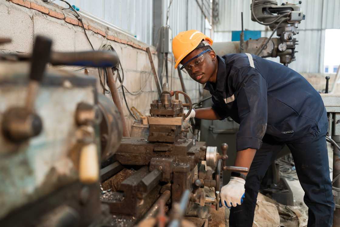 A male mechanics repairing a machine. A male mechanics repairing a machine.