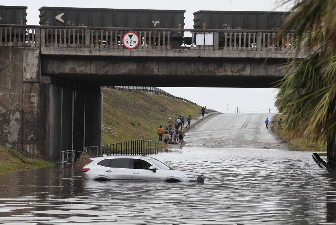 A woman died after her car was washed away during the Durban floods