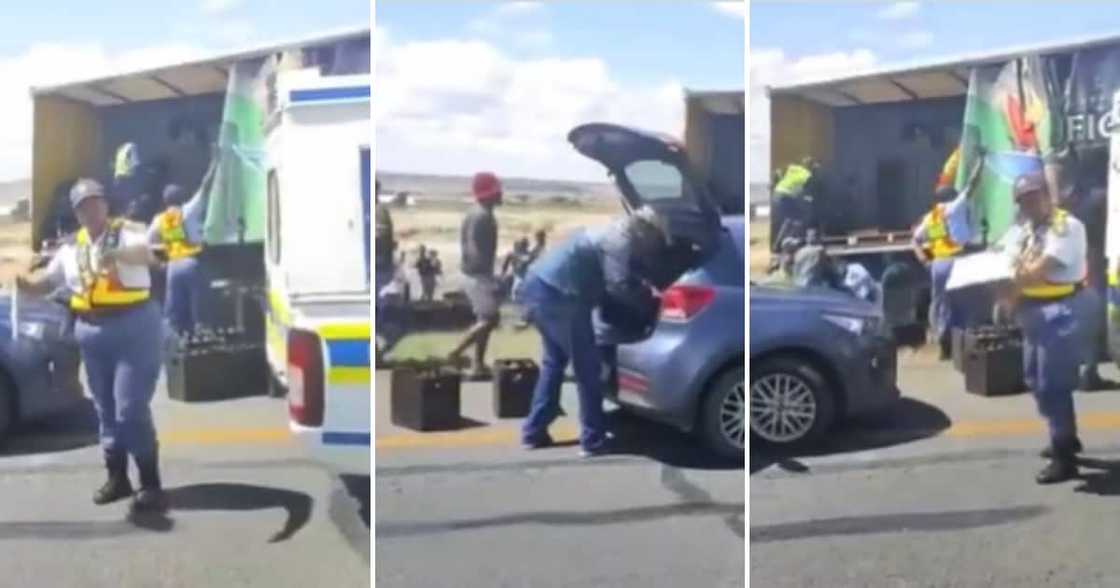 Police watching as a truck gets looted