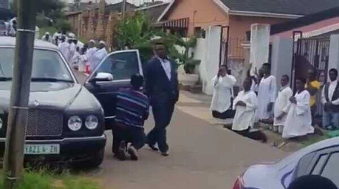 Photos and video of church members kneeling for pastor as he walks go viral