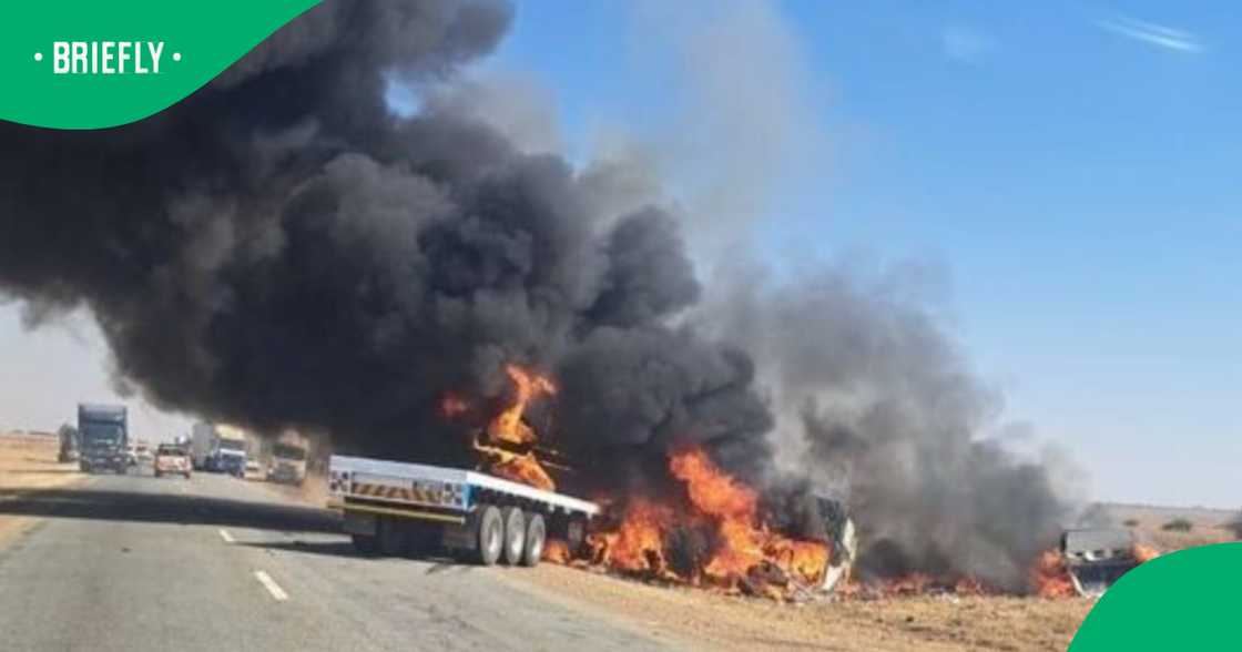 Trucks burn and smoke blows over road after two trucks collided. Trucks burn and smoke blows over road after two trucks collided.