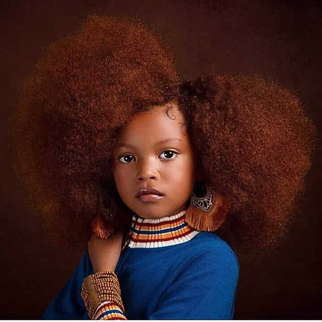 Afro puff with a side part. Afro puff with a side part.