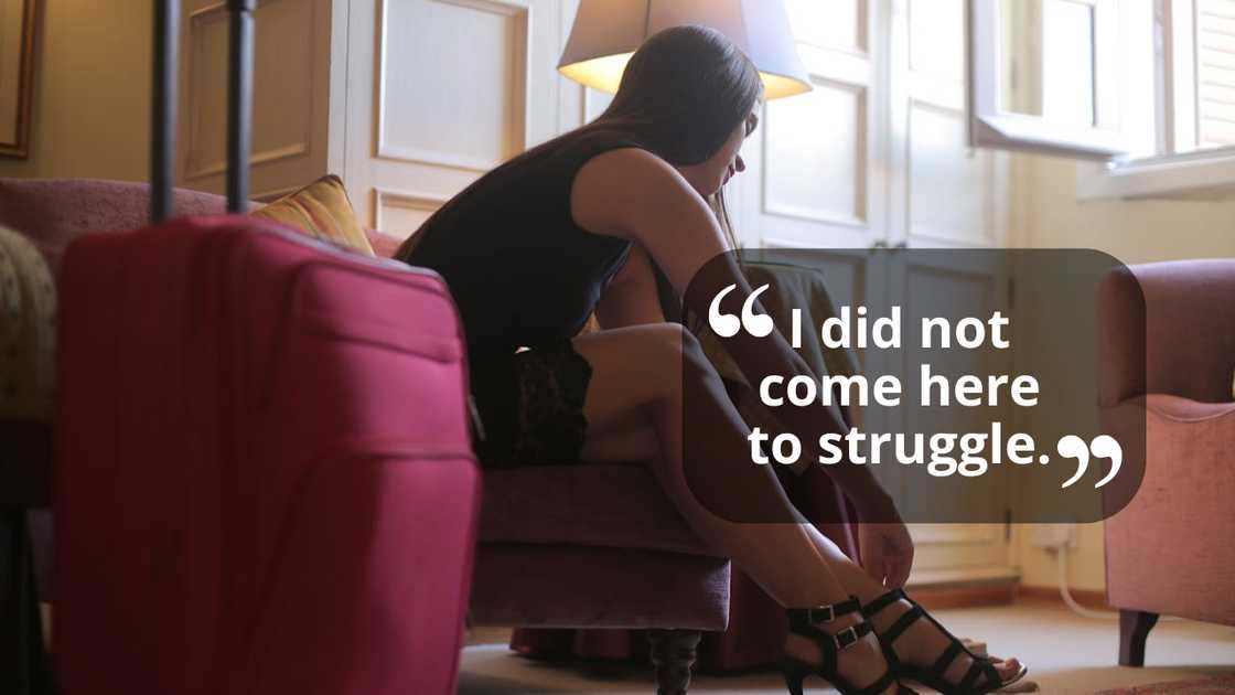 A woman sits beside a suitcase, looking down quietly. A woman sits beside a suitcase, looking down quietly.