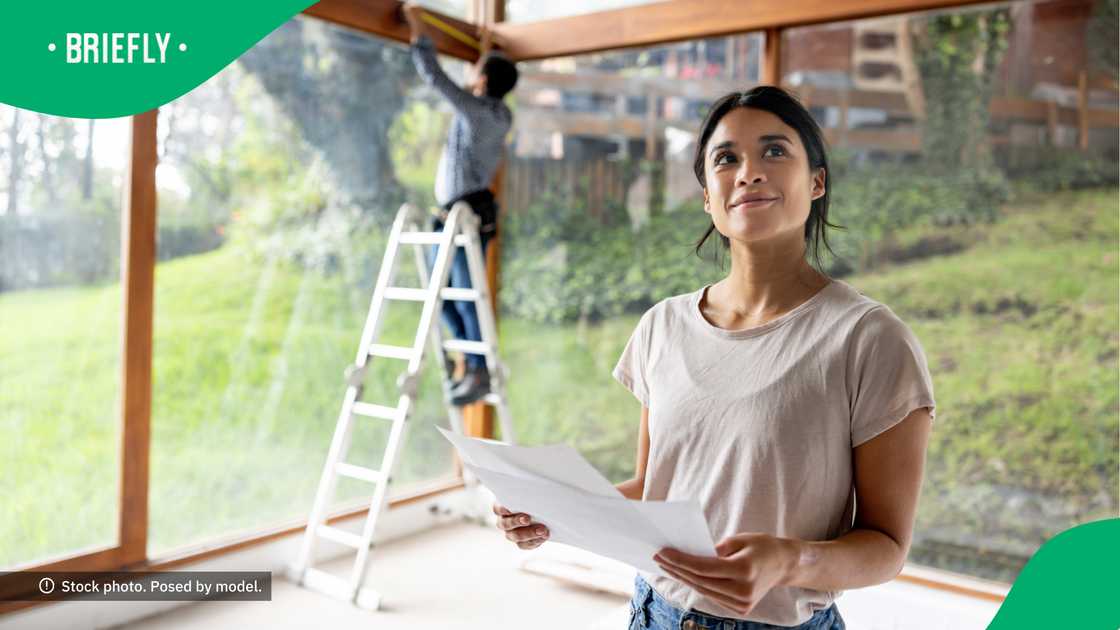 A lady showed how proud she was of her home construction efforts. A lady showed how proud she was of her home construction efforts.