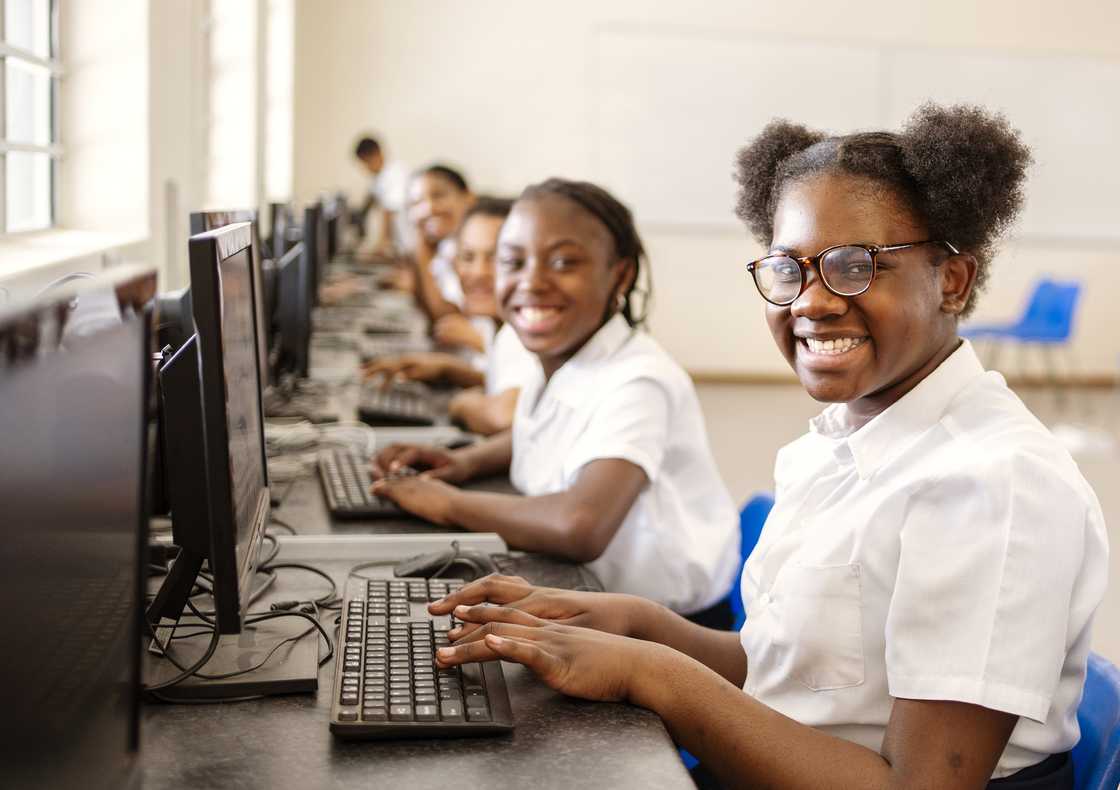 Children in uniform smiling at school. Children in uniform smiling at school.