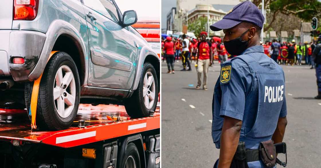 A car being towed, police officer facing protesters A car being towed, police officer facing protesters