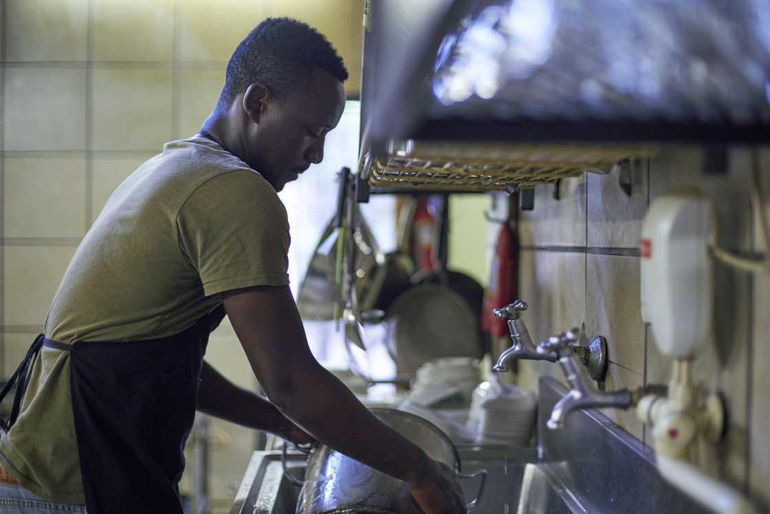 A man doing dishes in the kitchen