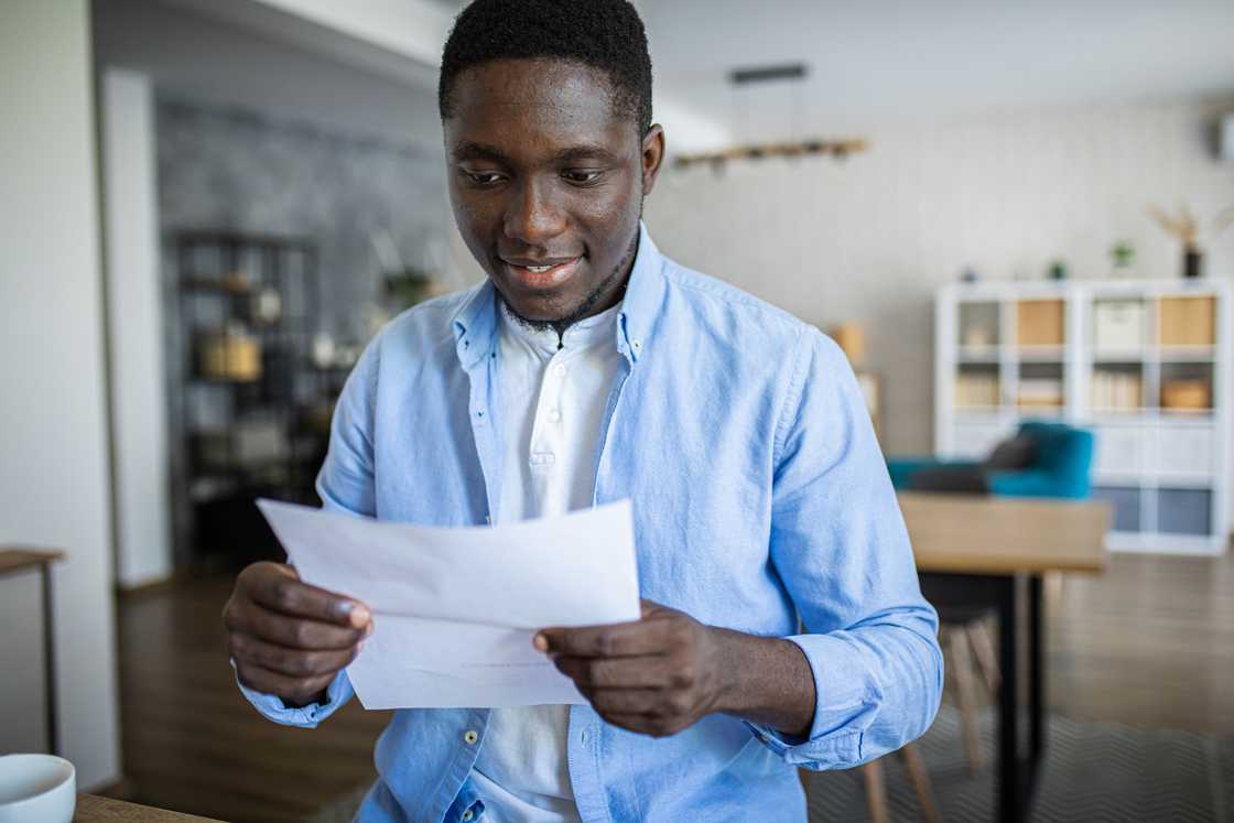 a young man holding internship letter a young man holding internship letter