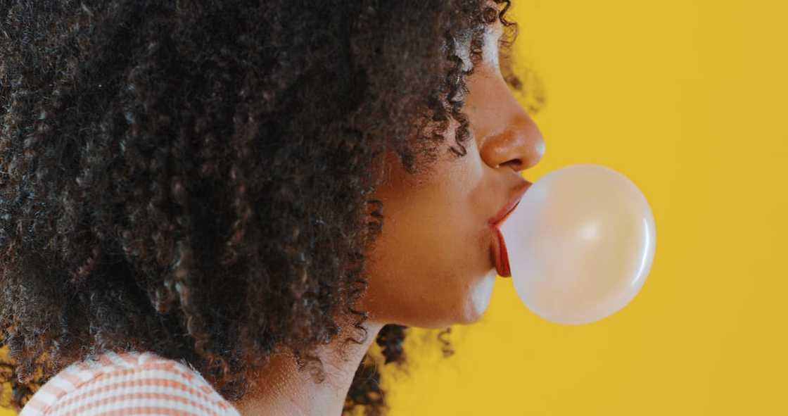 A woman blowing bubblegum A woman blowing bubblegum