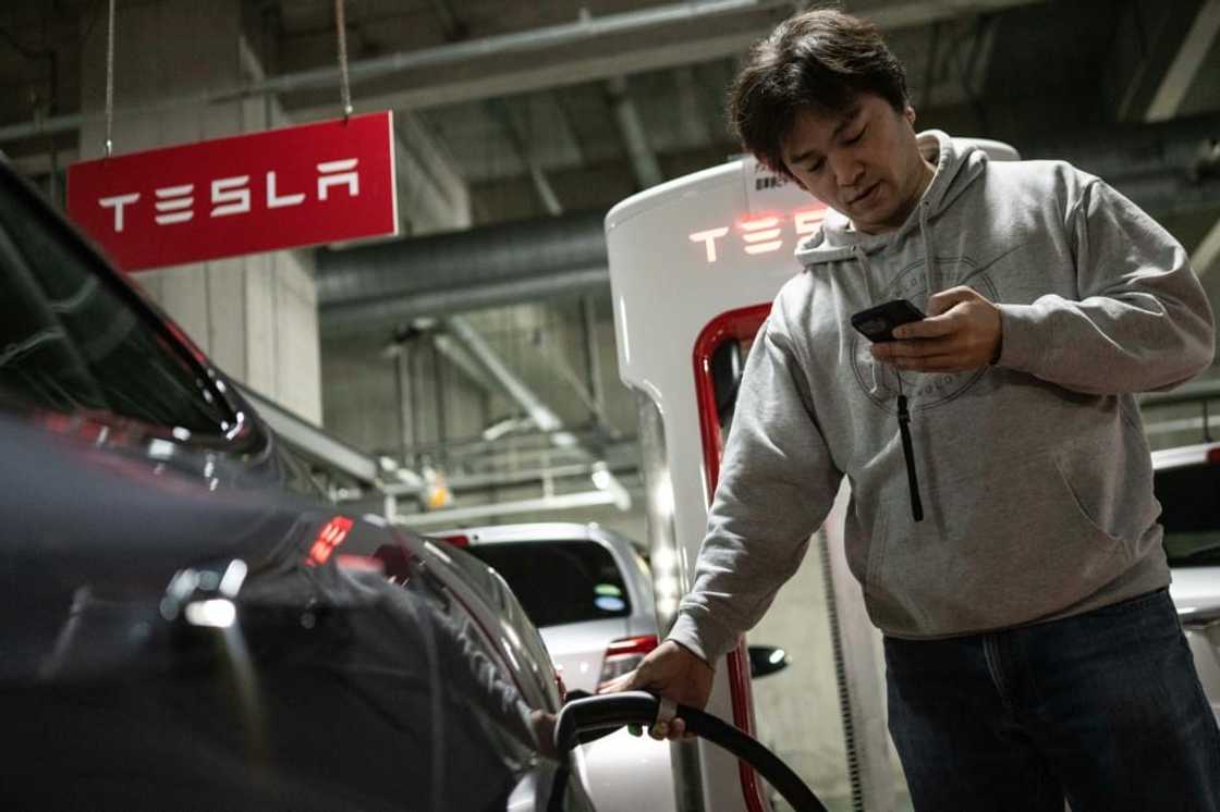 Atsushi Ikeda, founder of a club for Tesla owners in Japan, charges his Tesla Model S at a charging station in Tokyo Atsushi Ikeda, founder of a club for Tesla owners in Japan, charges his Tesla Model S at a charging station in Tokyo