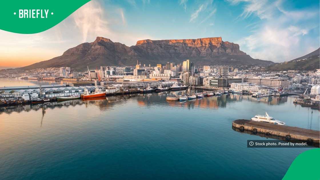 The V&A Waterfront was seen bustling with people, with boats resting in the harbour and Table Mountain towering in the background The V&A Waterfront was seen bustling with people, with boats resting in the harbour and Table Mountain towering in the background