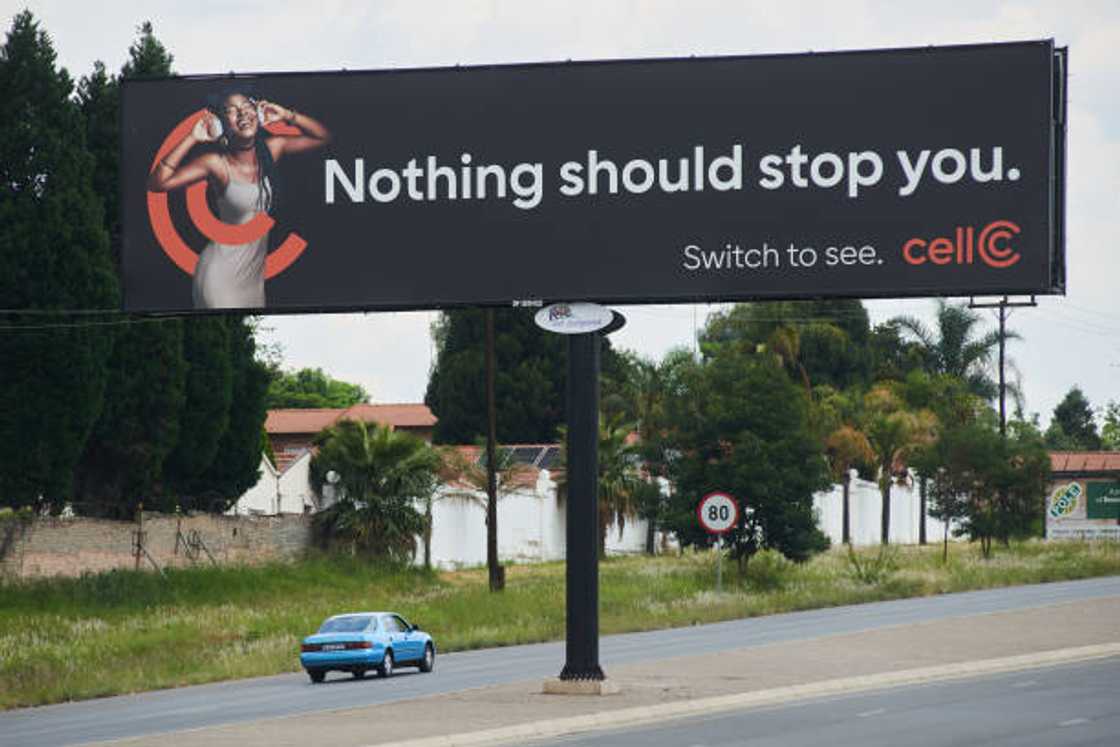 A Cell C advertisement billboard along the road A Cell C advertisement billboard along the road