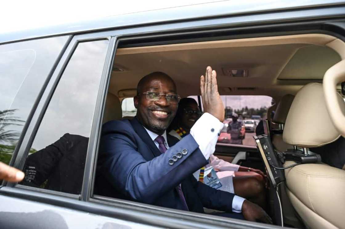 Wearing a suit and tie, the 50-year-old landed at the airport in the economic hub of Abidjan Wearing a suit and tie, the 50-year-old landed at the airport in the economic hub of Abidjan