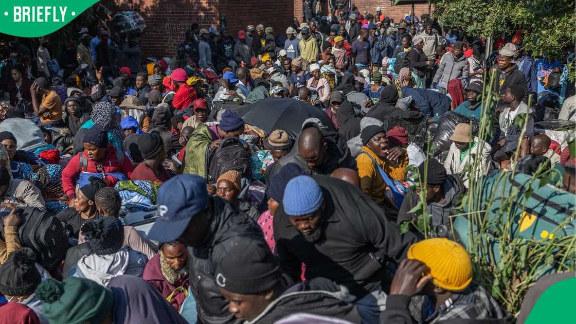 Displaced Malawian nationals prepare to board a bus at an abandoned municipality building on Mayor's Walk in Pietermaritzburg